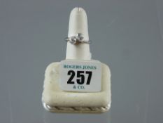 A white gold two stone diamond crossover dress ring, visual estimate 1 carat plus, 5.7 grms, size