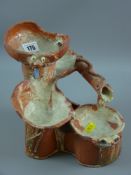 A primitive terracotta part glazed miniature water feature by 'Anelog', one of the three Queen Monks