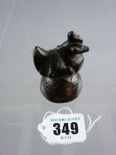 A heavy possibly Oriental, possibly bronze bird ornament or opium weight on a primitive circular