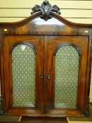 A Victorian flame mahogany side cabinet top with carved leaf embellishments, twin arched top doors