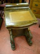 A Victorian walnut Davenport with top dome lidded box, gilt tooled leather skiver to the sloping