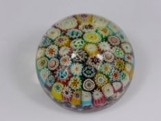 An Antique Millefiori Paperweight, of intricate design with various colourful canes, signed A.