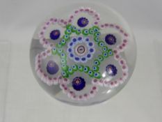 An Antique Paperweight, of intricate floral design highlighted with blue canes.