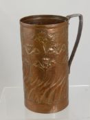 An Arts and Crafts Newlyn style copper jug having floral decoration, est. height 25 cms diameter