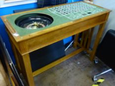 A Contemporary Wooden Gaming Table, Roulette Wheel and Black Jack etc and the top being