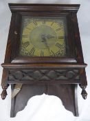 An Antique Brass Face Longcase Clock Movement, with oak wall case and sun face pendulum.
