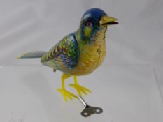 A Clock Work Tin Song Bird, 'Kohler Fubilierender Singvogel' in the original box with a key.