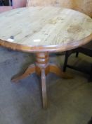 A round pine kitchen table on a bulbous turned centre column and four splayed feet, approx. 90