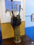 A vintage brass umbrella stand with ten assorted parasols / umbrellas together a Gunn & Moore