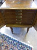A Campaign Style 5 graduated drawer Oak Cutlery Cabinet on stand, complete with fitted interior