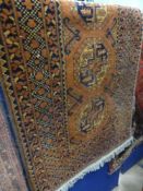 A Vintage Middle Eastern Style Woollen Rug. The rug having red and black background with three