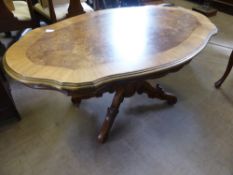 A Walnut Occasional Table, supported on decorative carved column and tripod base, 140 x 70 x 54.5