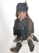 An Antique Porcelain Headed Doll, with sleeping eyes and open mouth revealing teeth, jointed