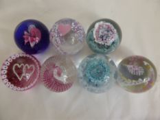 Seven Caithness Glass Paper Weights representing a wedding scene, two 