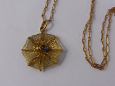 A 15ct Hallmarked Spider Web Pendant, the spider having a cabachon sapphire torso on rose gold