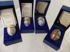 Four Halcyon Days Enamel Easter Eggs including years 2000, 2001, 2002 and 2004, in the original