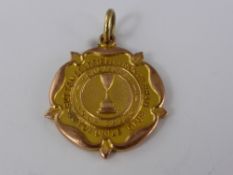 A 9ct Gold Presentation Medallion, the medallion reads 