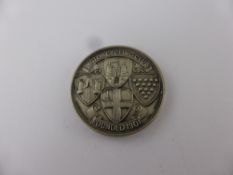 A Silver Medallion, reads 