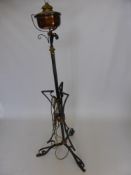 A Copper and Wrought Iron Lamp Stand, converted from an oil lamp with a lamp shade.