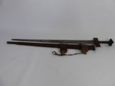 An Antique North African Sword, having a leather covered grip and quillion with tooled and decorated