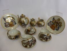 A Japanese Satsuma Part Tea Set, including tea pot, milk jug, double handled sugar bowl, two