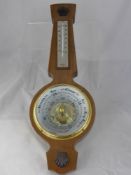 An Oak Cased Wall Barometer, manufactured by Short, Land Smith together with a circular wall