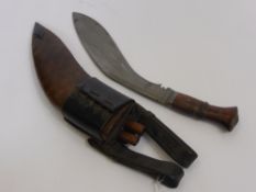 A Military Issue WW1 Ghurka Kukuri, in original tooled leather scabbard.