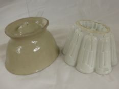 Two vintage jelly moulds, one mould forms a lion to the top.