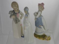 Three Ceramic Figures in the style of Lladro, hand made in Valencia, one of a girl with a bird in