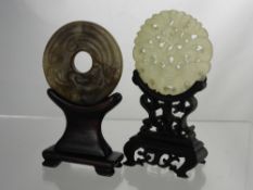Two Carved Jade Amulets, one white jade depicting a butterfly, the other fungi, both on stands. (2)