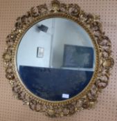 An Antique Gilt Wood Circular Mirror, the mirror having a shell and scroll form top, approx 72 x