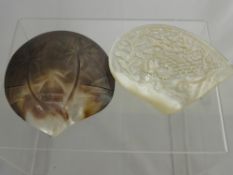 A Carved Mother of Pearl Shell, depicting birds together with another depicting a beach scene. (2)