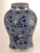 An Antique Blue and White Chinese Baluster Vase, painted with phoenix in flight amongst peony,