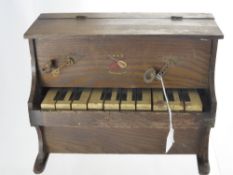 A Miniature Wooden 10 Key Piano, with tiny candelabra and the melody of 