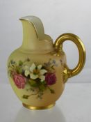 A Royal Worcester Blush Ware Jug, having a gilded handle, hand painted with a floral spray, nr