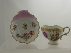 A Dresden Shell Form Cup and Saucer, hand painted with floral spray, Dresden mark to base.
