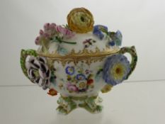 A Meissen Style Twin Handle Sugar Bowl and Cover, hand painted with butterflies and flower spray