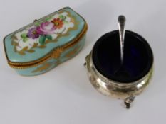 A Meissen Style Porcelain pill box together with a solid silver salt and spoon. (2)