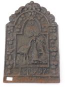 A Cast Iron Fire Back, depicting animals feeding from a vessel.