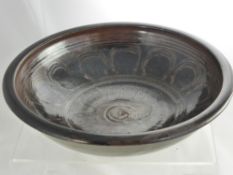 A Winchcombe Glazed Pottery Bowl, depicting black, green, mauve, brown design, approx 34 cms dia.