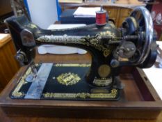An Oak Cased Singer Sewing Machine No. EC353626.