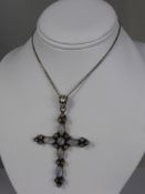 A Lady's Silver and Moonstone Cross Pendant, suspended from a silver 935 chain, the pendant