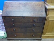 An Antique Oak Writing Bureau, with fitted interior including five internal drawers with pigeon