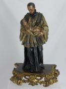 An 18th Century Religious Wood Sculpture, depicting a Priest and the Christ child, polychrome