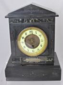 A Victorian Slate Mantle Clock, having marble inlay and silver engraved 