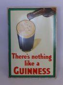 An Enamel Advertising Board for Guinness, which reads 