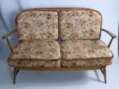 An Ercol Two Seater Teak Finish Cane Back Sofa, the sofa having original Ercol care label, approx