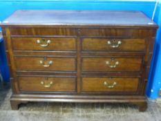 A Georgian Oak Mule Chest with six graduated drawers (two dummy), a hinged lid reveals a fitted