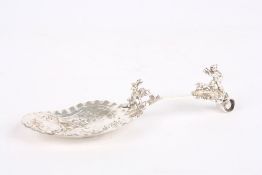 A Victorian silver caddy spoon, hallmarked London, with mounted figure of a boy shooting a dear