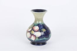 A Walter Moorcroft ‘Clematis’ vase, of baluster form with flared trumpet neck, the flowers painted
